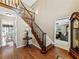 Inviting foyer with hardwood floors, a staircase, and views into the living and dining rooms at 3227 Heritage Way, Buford, GA 30519