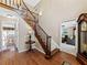 Inviting foyer with hardwood floors, a staircase, and views into the living and dining rooms at 3227 Heritage Way, Buford, GA 30519
