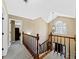 Upstairs hallway featuring decorative chandelier, and wood banister at 3227 Heritage Way, Buford, GA 30519