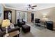 Comfortable home office featuring a sofa set, work desk, ceiling fan, and a window at 3227 Heritage Way, Buford, GA 30519