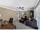 Cozy home office with a ceiling fan, brown sofa set, and natural light at 3227 Heritage Way, Buford, GA 30519