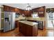 Kitchen boasts stainless appliances, wood cabinets, and center island with granite counters at 3227 Heritage Way, Buford, GA 30519