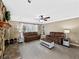 Comfortable living room featuring a stone fireplace, large windows, and neutral-toned sofas at 3227 Heritage Way, Buford, GA 30519