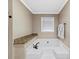 Bathroom featuring a built-in white soaking tub with granite ledge at 3227 Heritage Way, Buford, GA 30519