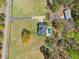Aerial view showcasing a home with a pool, a vast lawn, and surrounding trees at 5660 Trout Creek Dr, Douglasville, GA 30135