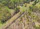 Expansive aerial view of a beautiful property with a home surrounded by lush greenery and mature trees at 5660 Trout Creek Dr, Douglasville, GA 30135