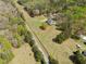 An aerial view reveals a home with a pool, set on a large lot amidst lush greenery and mature trees at 5660 Trout Creek Dr, Douglasville, GA 30135