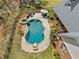 Backyard oasis showcasing a freeform pool, hot tub, and outdoor seating area with mature landscaping at 5660 Trout Creek Dr, Douglasville, GA 30135