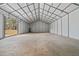 Interior of a large barn or outbuilding with high ceilings and concrete flooring, offering versatile space at 5660 Trout Creek Dr, Douglasville, GA 30135
