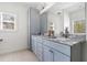 Bathroom with double vanity, granite countertop, and abundant natural light at 5660 Trout Creek Dr, Douglasville, GA 30135