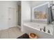 Bright bathroom featuring jacuzzi tub, shower, and decorative accents at 5660 Trout Creek Dr, Douglasville, GA 30135