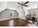 Expansive bonus room features hardwood flooring, a ceiling fan, and windows overlooking the backyard at 5660 Trout Creek Dr, Douglasville, GA 30135
