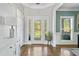 Bright foyer featuring hardwood floors, decorative glass door, and a stylish console table with elegant decor at 5660 Trout Creek Dr, Douglasville, GA 30135