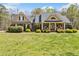 Charming brick home featuring manicured landscaping, a welcoming front porch, and a symmetrical facade at 5660 Trout Creek Dr, Douglasville, GA 30135