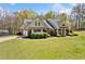 Landscaped home showcasing brick and siding accents, manicured shrubs, and a well-maintained front lawn at 5660 Trout Creek Dr, Douglasville, GA 30135