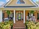 Inviting front porch with comfortable seating, charming decor, and a welcoming entrance with brick steps at 5660 Trout Creek Dr, Douglasville, GA 30135