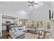 Open-concept living room featuring high ceilings, a cozy sectional sofa, and a seamless connection to the kitchen at 5660 Trout Creek Dr, Douglasville, GA 30135