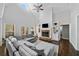 Bright living room with a stone fireplace, built-in shelves, and a comfortable sectional sofa for relaxing and entertaining at 5660 Trout Creek Dr, Douglasville, GA 30135