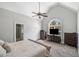Spacious main bedroom with vaulted ceiling, large window, and ensuite bathroom entrance at 5660 Trout Creek Dr, Douglasville, GA 30135