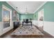 Stylish home office with wainscoting, dark hardwood floors, and a large window offering ample natural light at 5660 Trout Creek Dr, Douglasville, GA 30135