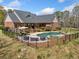 Back of house view displaying a private pool, deck, and fenced yard perfect for outdoor enjoyment at 5660 Trout Creek Dr, Douglasville, GA 30135