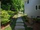 This exterior landscape showcases a stone path that meanders gently through lush greenery at 710 Greystone Ne Park, Atlanta, GA 30306