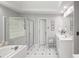 Bright bathroom featuring a soaking tub with glass block window and a separate glass door shower at 710 Greystone Ne Park, Atlanta, GA 30306