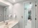 Bright bathroom showcasing a well-lit vanity with an adjacent walk-in shower and hall view at 710 Greystone Ne Park, Atlanta, GA 30306