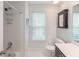 Clean bathroom featuring a shower over tub, toilet, vanity, and storage mirror for convenience at 710 Greystone Ne Park, Atlanta, GA 30306