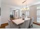 Refined dining room with a modern chandelier, seating for six, neutral decor, and an open layout at 710 Greystone Ne Park, Atlanta, GA 30306