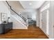 Bright foyer featuring a staircase, hardwood floors, an entryway table, and direct access to a sunny living room at 710 Greystone Ne Park, Atlanta, GA 30306
