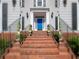 Inviting front entrance with a vibrant blue door, brick steps, decorative planters, and stylish outdoor lighting at 710 Greystone Ne Park, Atlanta, GA 30306
