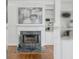 Elegant fireplace with marble surround and white mantle flanked by built-in bookshelves in a bright living room at 710 Greystone Ne Park, Atlanta, GA 30306