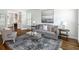 Cozy living room with a neutral color scheme, hardwood floors, and glass French doors leading to a fireplace at 710 Greystone Ne Park, Atlanta, GA 30306