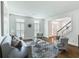 Comfortable living room with hardwood floors, grey couches, and natural light from large windows at 710 Greystone Ne Park, Atlanta, GA 30306