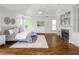 Spacious main bedroom with fireplace, tray ceilings, and hardwood floors at 710 Greystone Ne Park, Atlanta, GA 30306