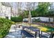 Spacious backyard featuring a stone patio with seating, creating an inviting outdoor space at 710 Greystone Ne Park, Atlanta, GA 30306
