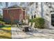 Outdoor living area boasting a stone patio and a cozy fire pit table for entertaining guests at 710 Greystone Ne Park, Atlanta, GA 30306