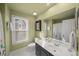 Well-lit bathroom with vanity, mirror, and white tile flooring at 710 Greystone Ne Park, Atlanta, GA 30306