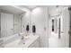 Clean bathroom featuring white vanity, large mirror, and tiled floors at 710 Greystone Ne Park, Atlanta, GA 30306