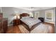 Spacious bedroom featuring a bed, bedside tables, lamps, and a work desk with great natural light at 710 Greystone Ne Park, Atlanta, GA 30306
