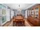 Elegant dining room with hardwood floors, large windows, and a classic china cabinet at 710 Greystone Ne Park, Atlanta, GA 30306