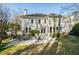 Back exterior view showcasing a well-maintained lawn, stone patio and multiple windows at 710 Greystone Ne Park, Atlanta, GA 30306