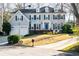 Stately two-story home with a manicured lawn, attached garage, and a welcoming blue front door at 710 Greystone Ne Park, Atlanta, GA 30306