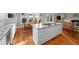 Bright kitchen with white cabinets, granite countertops, stainless appliances, and a spacious island cooktop at 710 Greystone Ne Park, Atlanta, GA 30306