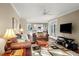 Open-concept living room with hardwood floors, a view of the kitchen, and a large TV at 710 Greystone Ne Park, Atlanta, GA 30306