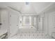 Bright main bathroom with a skylight, a soaking tub, and a glass-enclosed shower at 710 Greystone Ne Park, Atlanta, GA 30306
