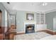 This is an image of a bedroom with a fireplace, hardwood flooring, and lots of light at 710 Greystone Ne Park, Atlanta, GA 30306