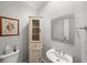 Cozy powder room features a toilet and sink with a decorative mirror at 710 Greystone Ne Park, Atlanta, GA 30306