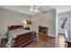 An inviting bedroom with hardwood floors, a large window with natural light, a ceiling fan and neutral colored walls at 1007 Springharbor Walk, Woodstock, GA 30188